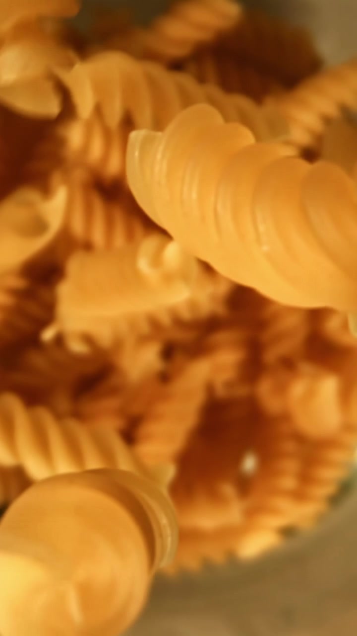 Uncooked Fusilli Pasta Falling in Slow Motion Close-Up