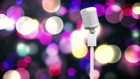 Retro-white-microphone-against-colorful-spots-of-light-against-black-background