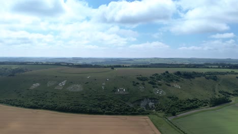 Aerial-view-rising-above-the-set-of-regimental-badges-carved-into-Fovant-chalk-hillside-in-the-Wiltshire-countryside