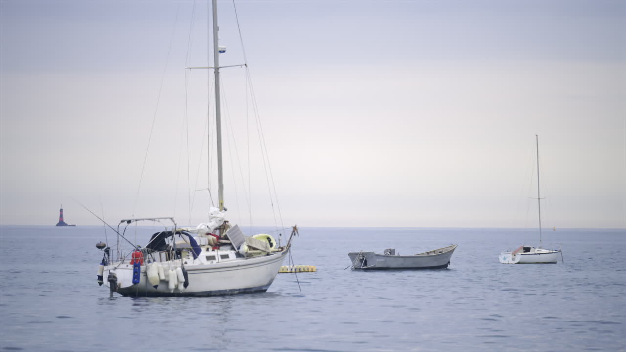Multiple white boats docked on the sea in daylight in the French Riviera
