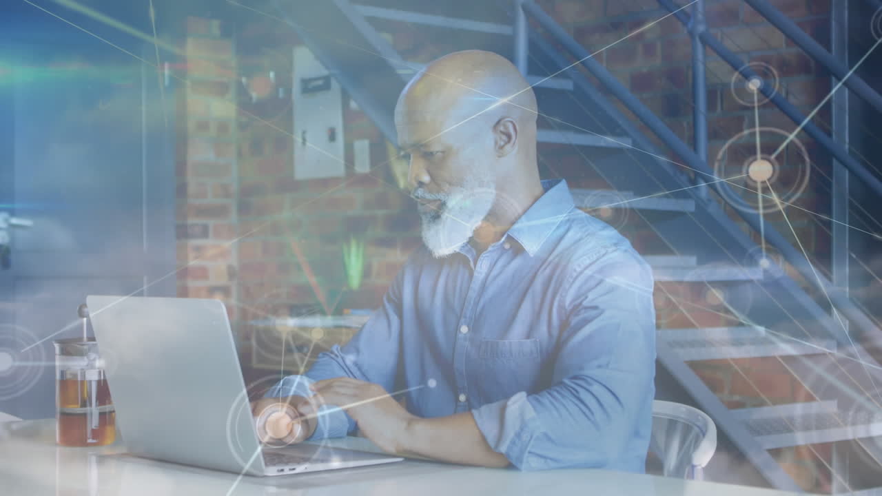 Animation of networks of connections over senior man using laptop