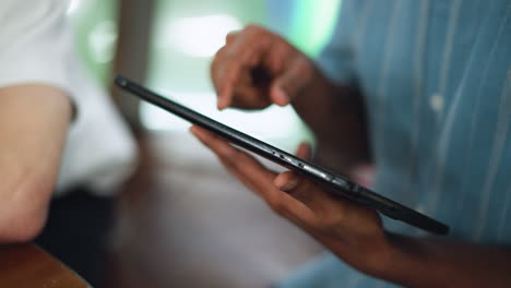 tight closeup of hand dabbing fingertip on tablet screen while ink sketch lies nearby subtle motion blur captures delicate interaction between touch and canvas digital tool meets analog art