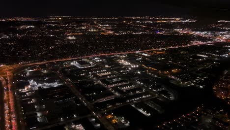 Flying-over-Montreal-city-at-night,-Quebec-in-Canada