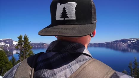 guy looking at crater lake in oregon