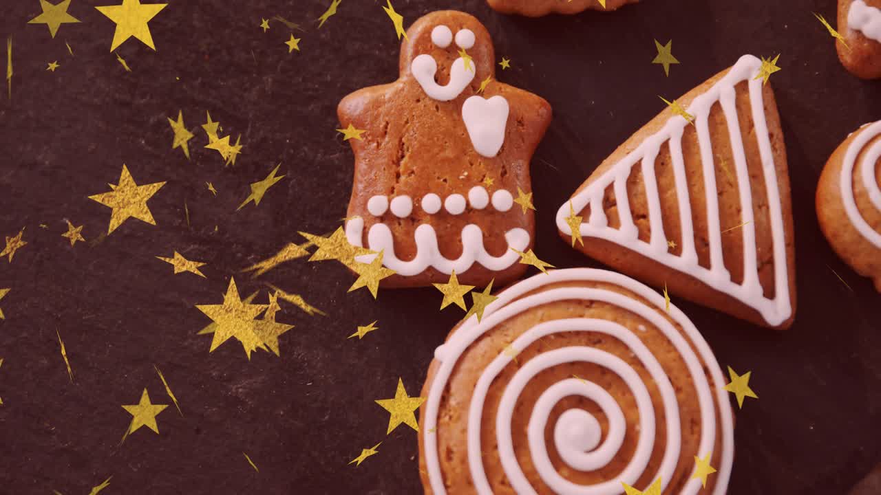 Gold star confetti starting falling over iced gingerbread cookies, creating festive pattern