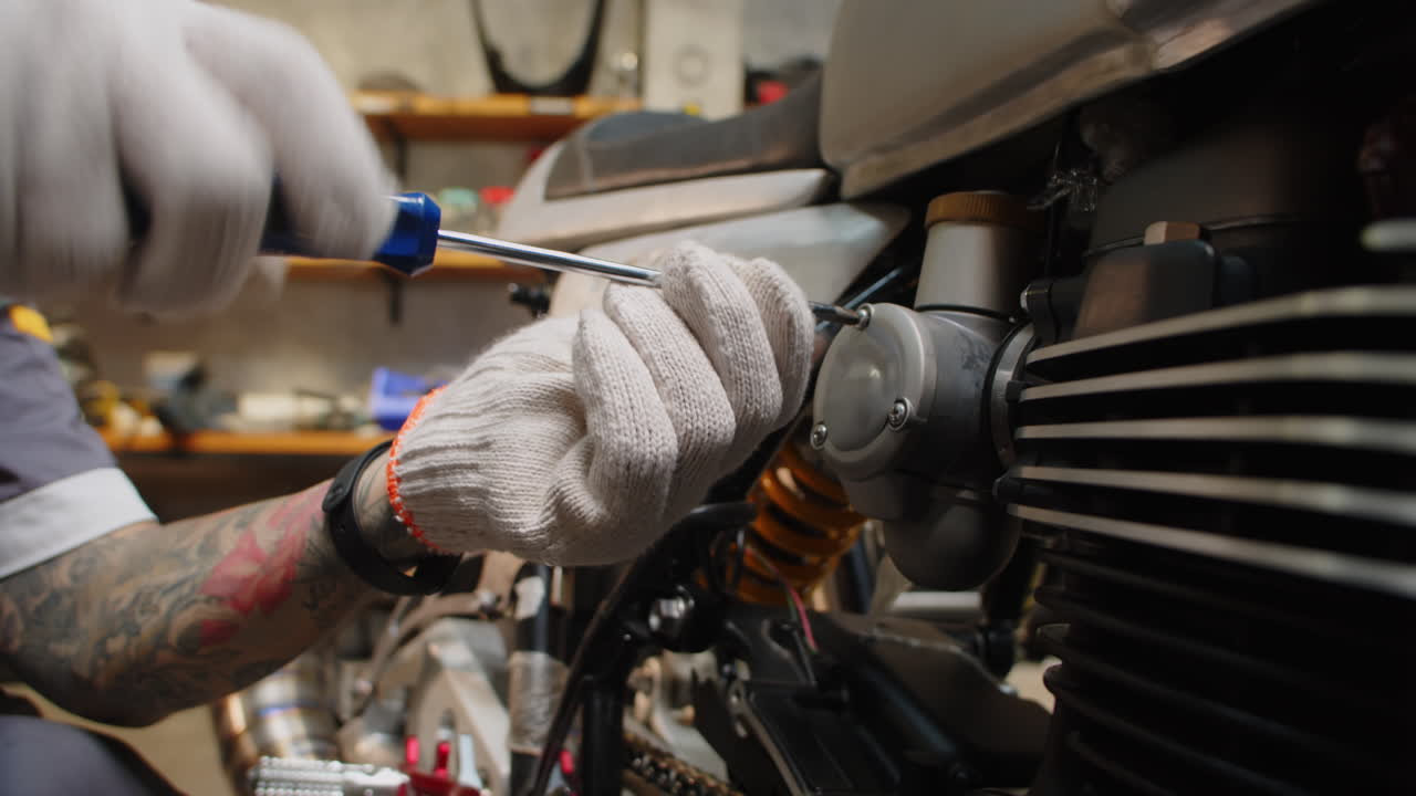 Unrecognizable Repairman Fixing Broken Motorbike