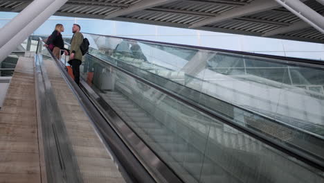 couple on an airport escalator