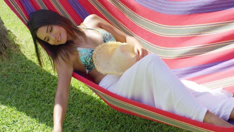 close up of woman sleeping in hammock