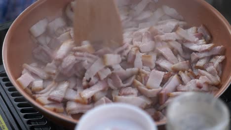saltear la carne de cerdo en pequeños cortes en una sartén