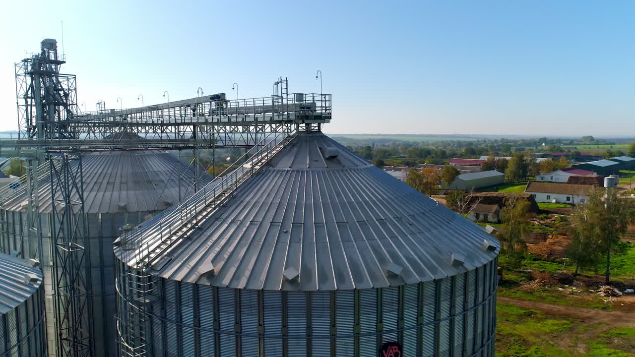 Metal elevator for crop. Silo for storing grain in the countryside. Exterior of large storage tanks for agricultural products. View from above.