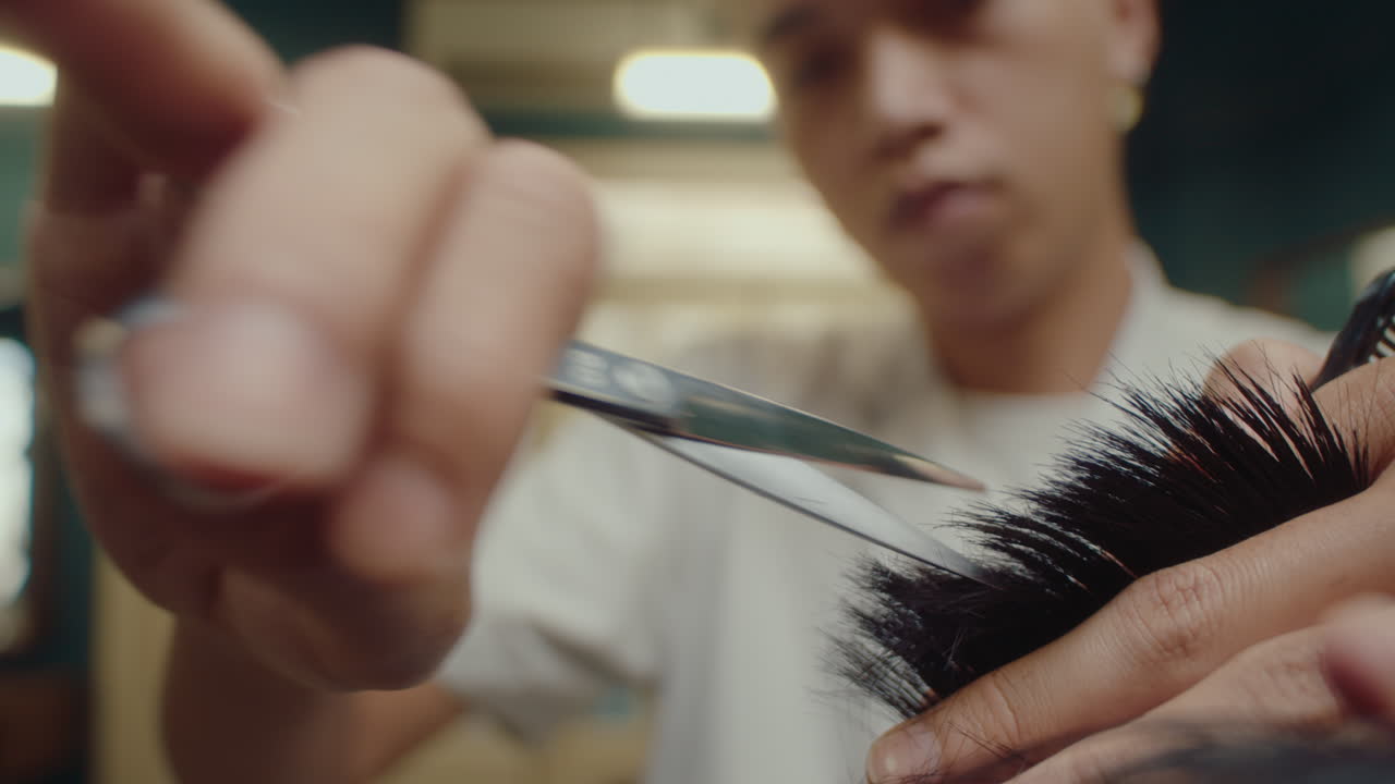 Hands of Barber Trimming Hair with Shears