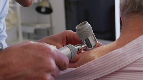 doctor examining a senior man in a retirement home