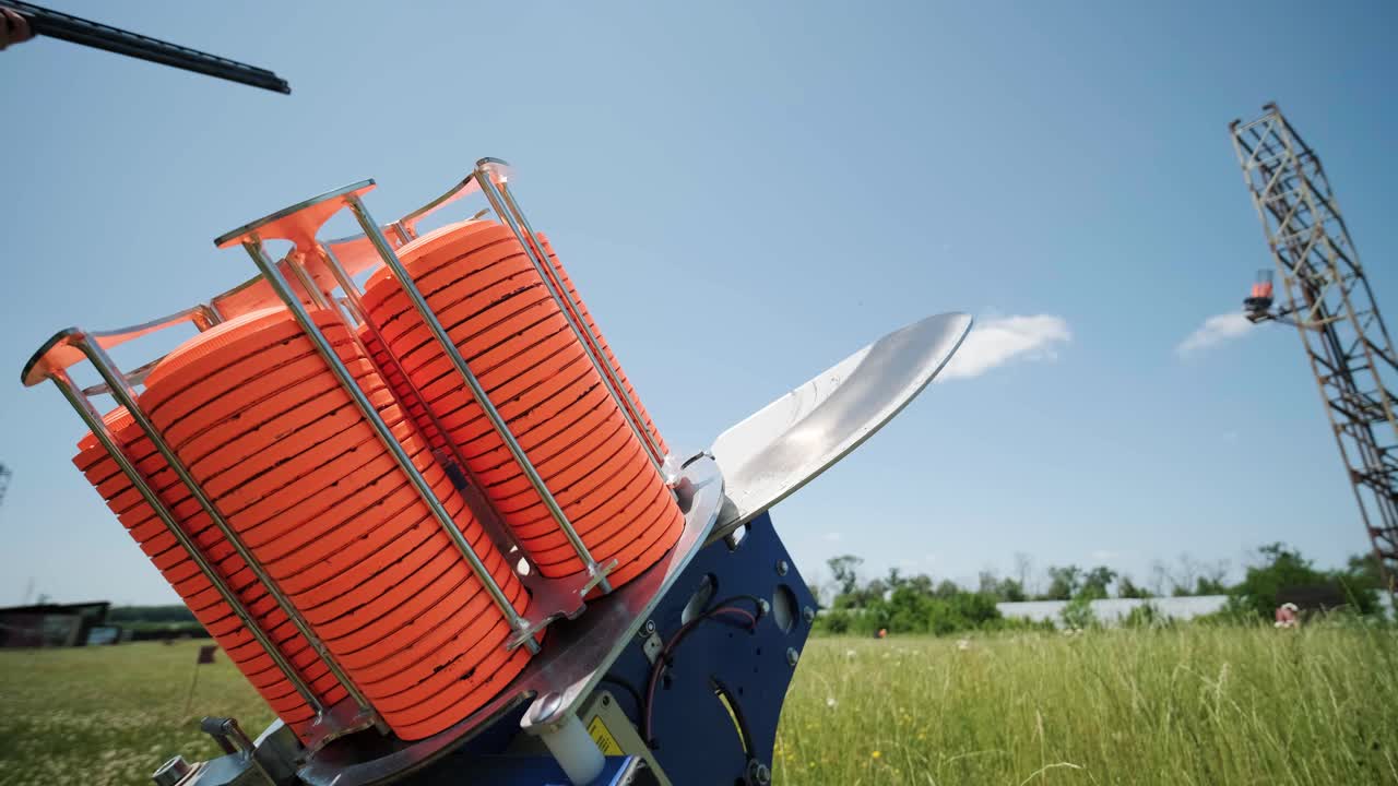 스포츠맨이 이중 배럴 건으로 총을 고, 슈팅 테스트를 위한 스포츠 경기장은 날아다니는 스케이트를 고 있습니다.