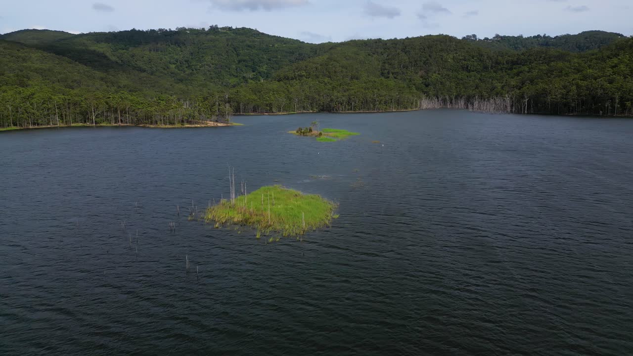 Circular aerial views of a small island on Advancetown Lake near the Western Boat Ramp on the Gold Coast Hinterland.