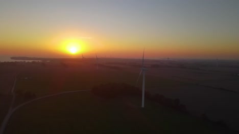 scenic windmill energy electricty factory during a yellow sunset view