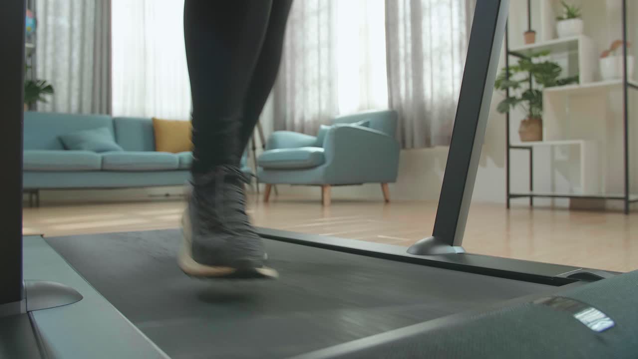 Front View Legs Of Asian Woman Running On A Treadmill At Home