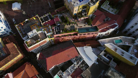 Cartagena,-Colombia,-Aerial-View-of-Old-Town-Colonial-Buildings-Rooftops,-Harbor-and-Coastal-Traffic,-Revealing-Tilt-Up-Drone-Shot