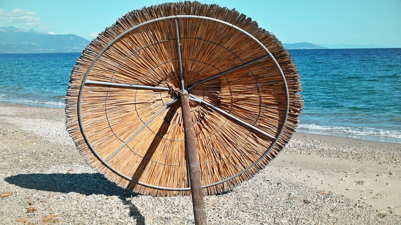 Beach umbrella lying on the Aegean sea coast in Asprovalta, Greece