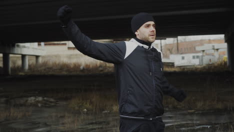 man exercising under a bridge in urban environment
