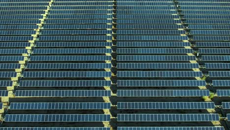 Field-of-solar-panels-in-Mojave,-aerial-pullback-during-the-day,-photovoltaic-system