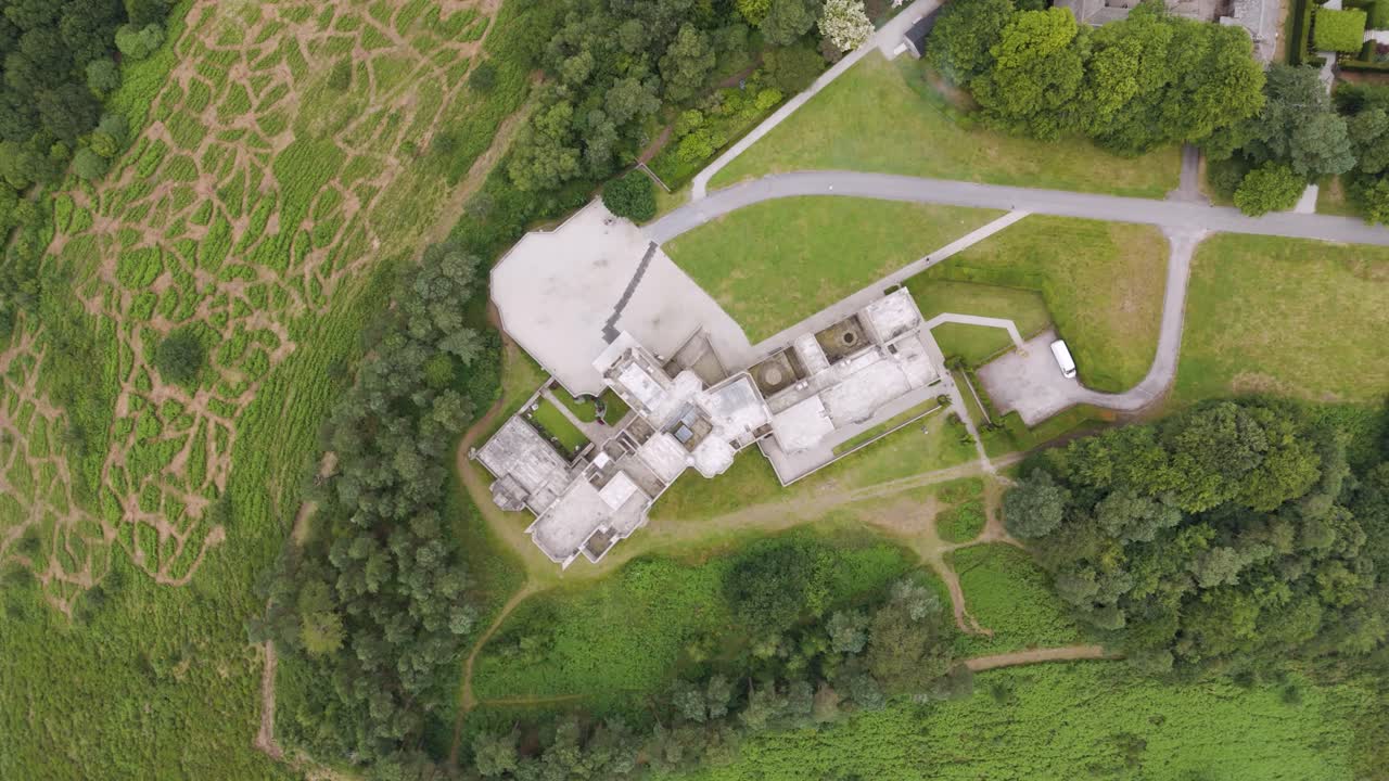 Aerial View of a Large Building Complex Surrounded by Lush Green Landscape