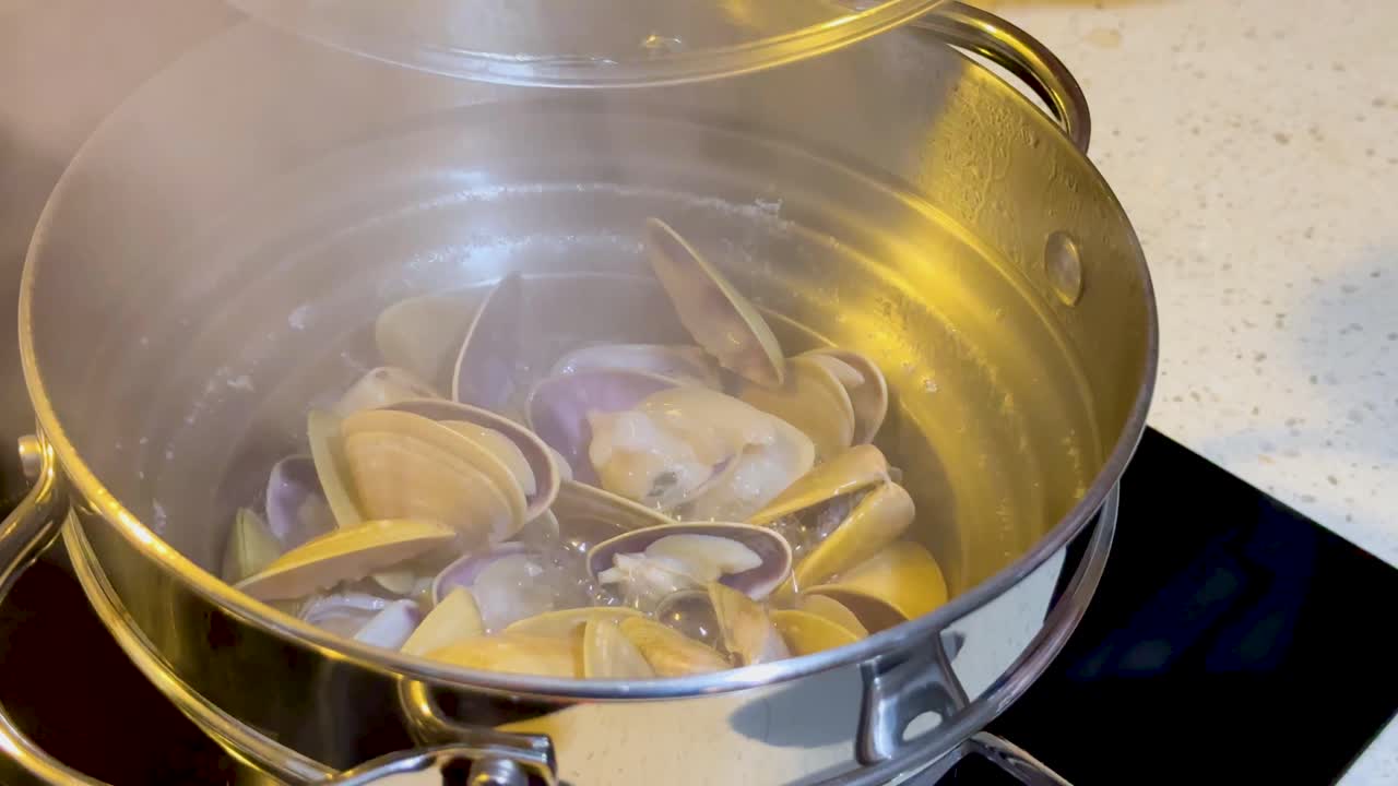 Clams steaming in a pot on the stove