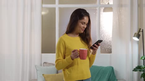 Caucasian-woman-using-his-phone-and-drinking-coffee