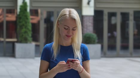 woman texting on smartphone outdoors