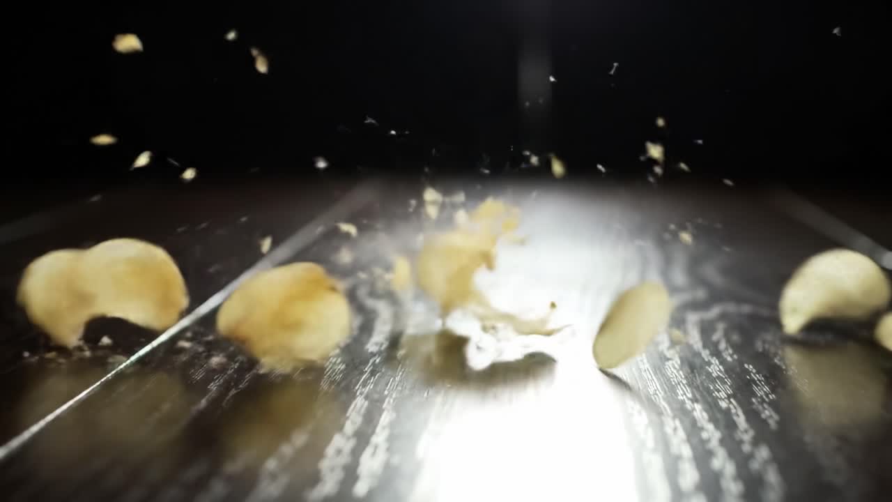 Falling Potato Chips Creating a Crunchy Scatter on a Wooden Surface with Dramatic Lighting, Capturing the Essence of Snack Time Delight