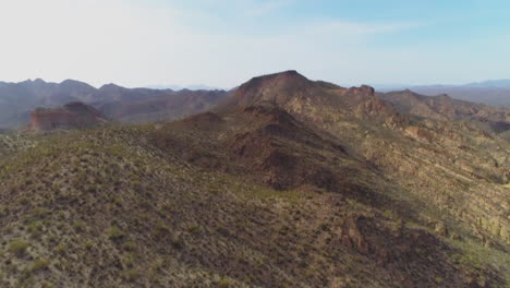 aerial - drone tilt up to reveal desert mountain