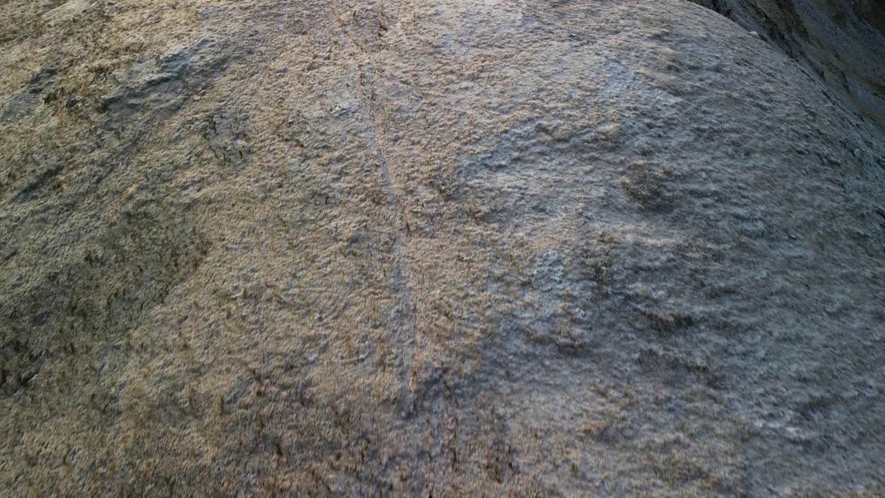 Hillwalking in Glen Coe, Scottish Highlands - aerial top down of walker hiking along ridge looking small in wide landscape