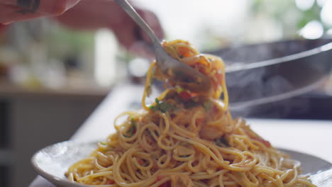 serving creamy pasta with shrimps on plate