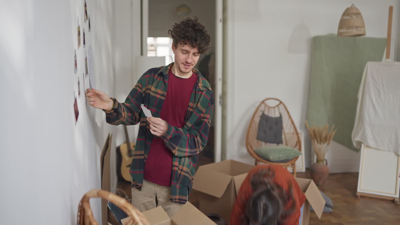 Couple looking at a photo while moving into a new home