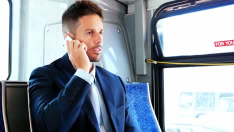businessman talking on mobile phone while travelling