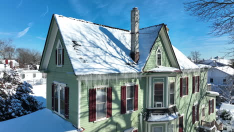 Icicles-in-winter-snow-drip-from-house-rooftop-spouting