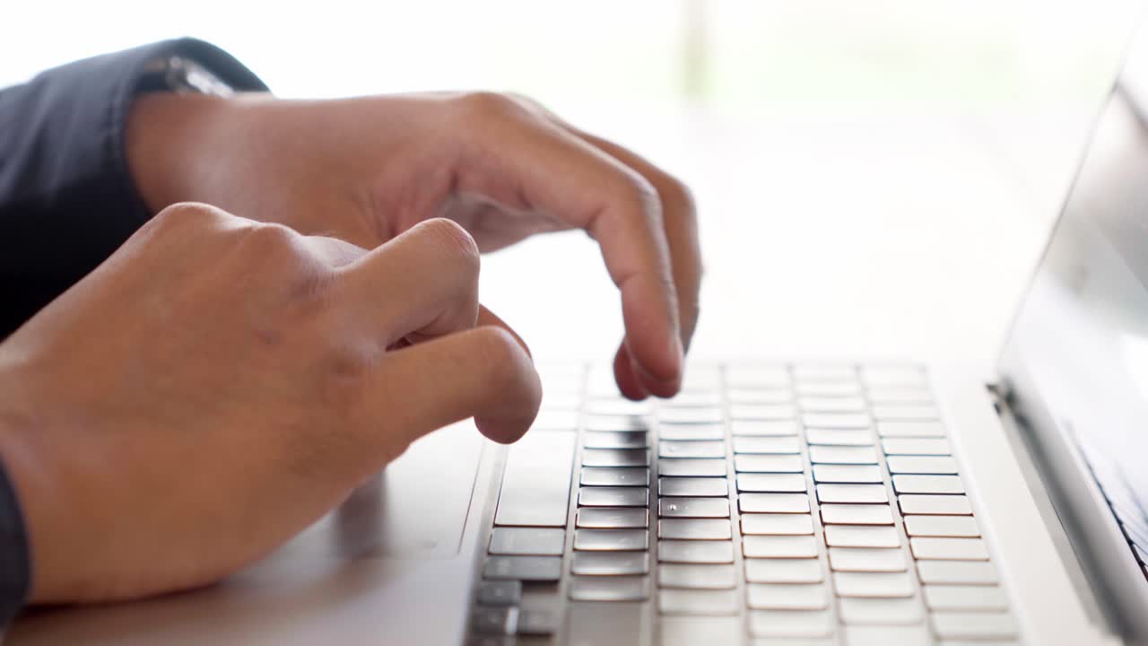 Close up of hand typing on laptop keyboard