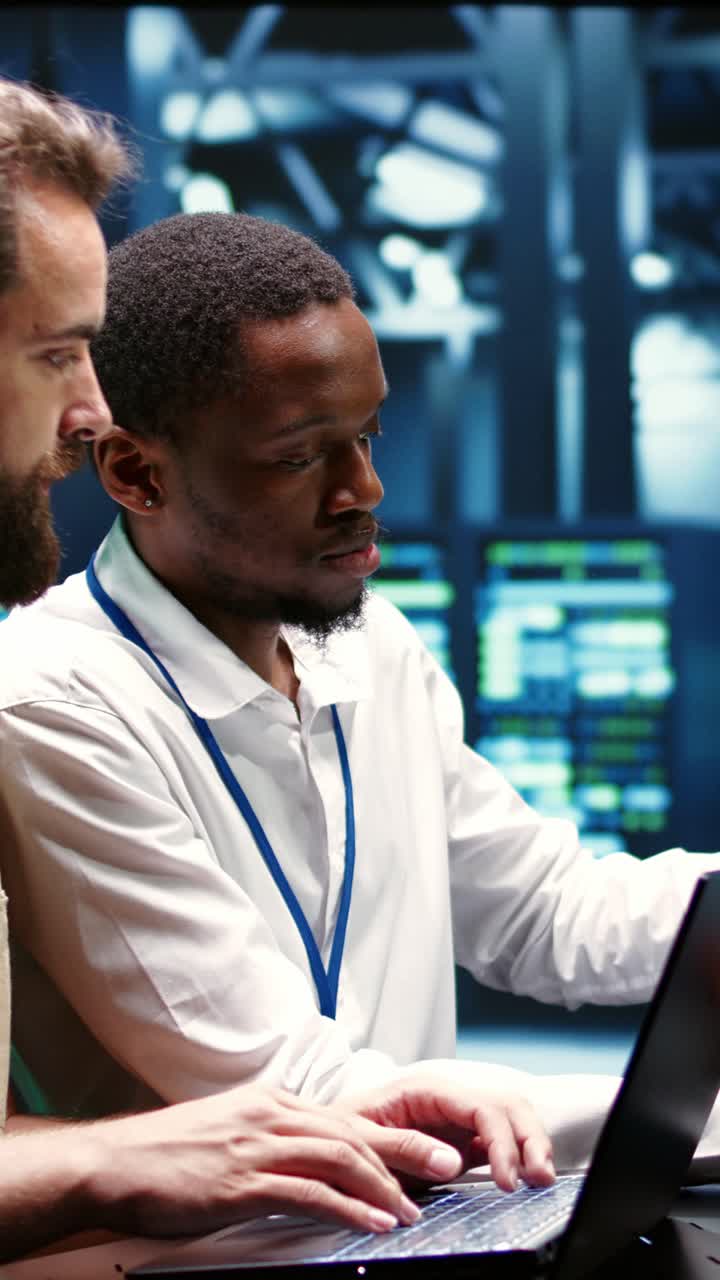 Vertical video Coworkers running data center tests