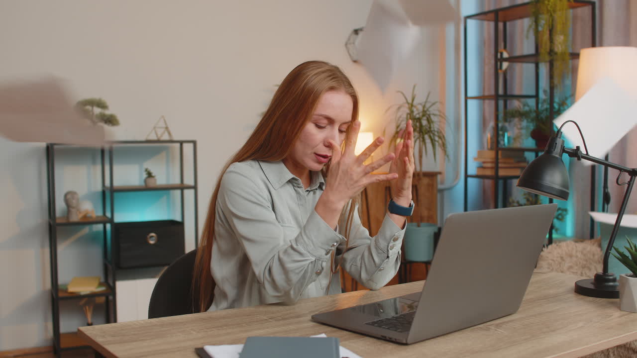 Stressed upset businesswoman with laptop looking at unpaid bank debt bills sitting at home desk