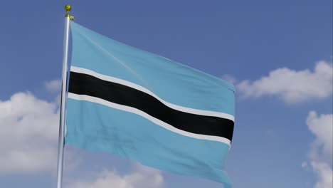 Bandera-De-Botswana-Moviéndose-En-El-Viento-Con-Un-Cielo-Azul-Claro-En-El-Fondo,-Nubes-Moviéndose-Lentamente,-Asta-De-Bandera,-Cámara-Lenta