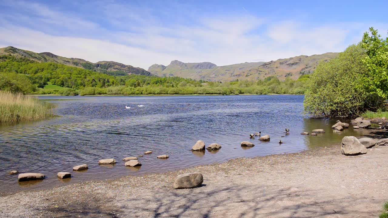 Rocks lining a beautiful river stream in the England Lake District - wide shot