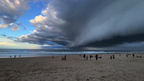 wide angle panning view at the beach in surfers paradise capturing dramatic ominous dark stormy clouds covering the sky, extreme weather, wet and wild season forecasted, gold coast, queensland