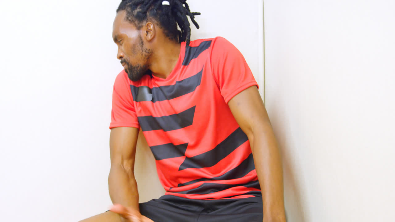 Frustrated athlete sitting in the locker room 4k