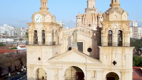 Aerial-dolly-in-shot-capturing-the-Catedral-In-Cordoba,-toward-the-statue-of-Christ-the-King-on-cathedral-roof-during-daytime