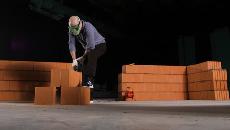 construction worker cutting bricks