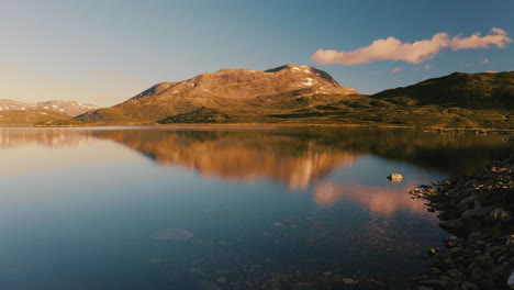 The-beautiful-morning-light-over-the-Norwegian-mountains-and-lake---low-aerial