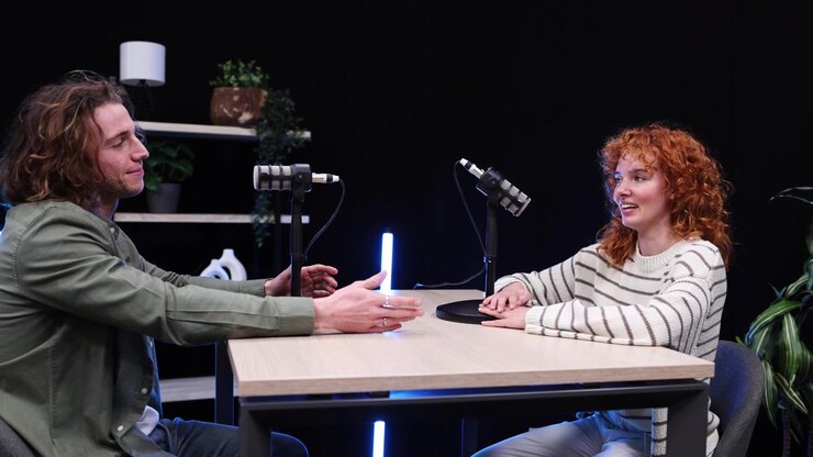Young Man and Woman Recording a Podcast in a Studio