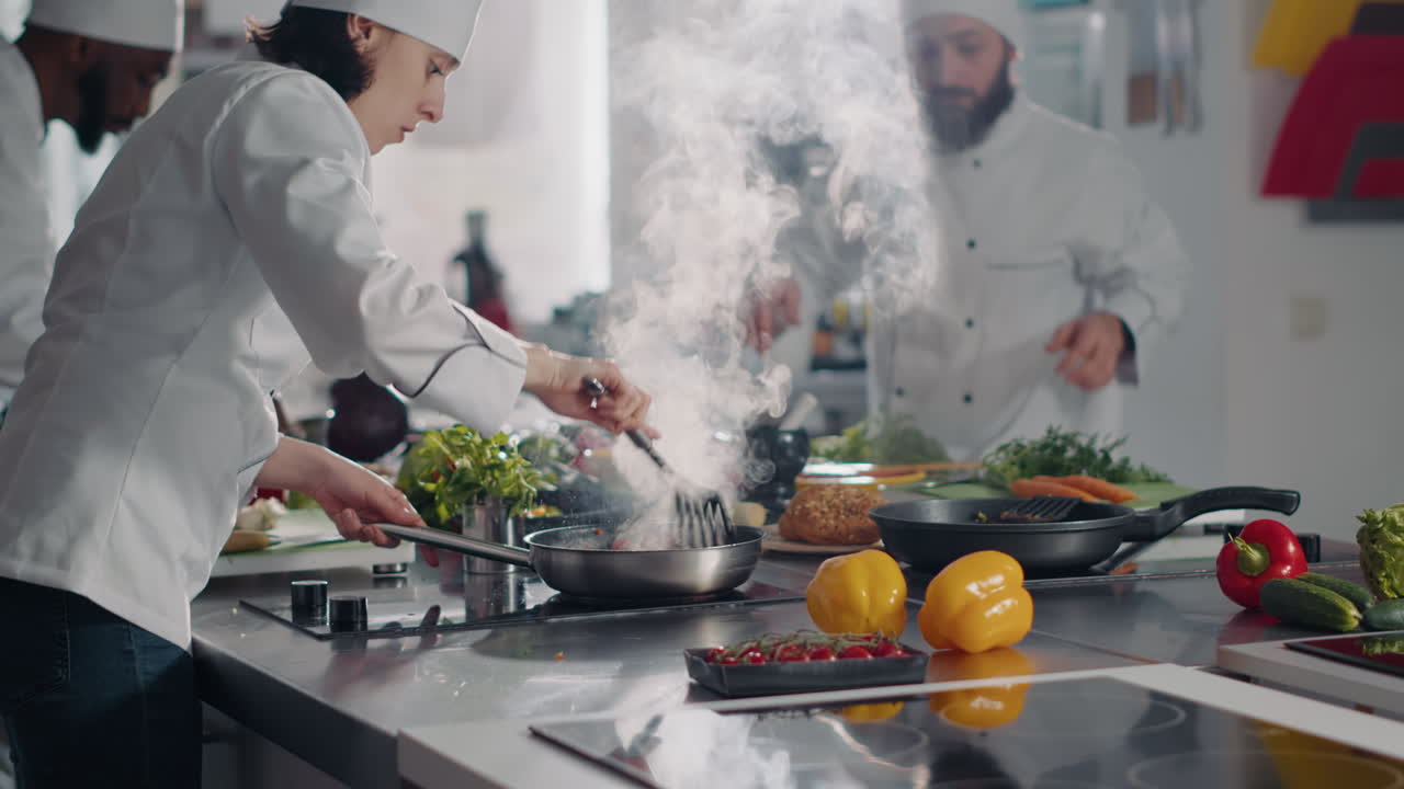 Woman using frying pan to cook vegetables on kitchen stove
