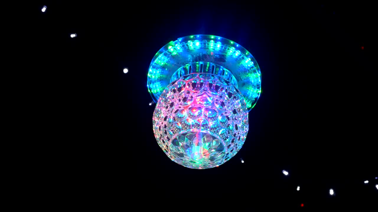 Disco mirror ball center wide with RGB color light in night time.