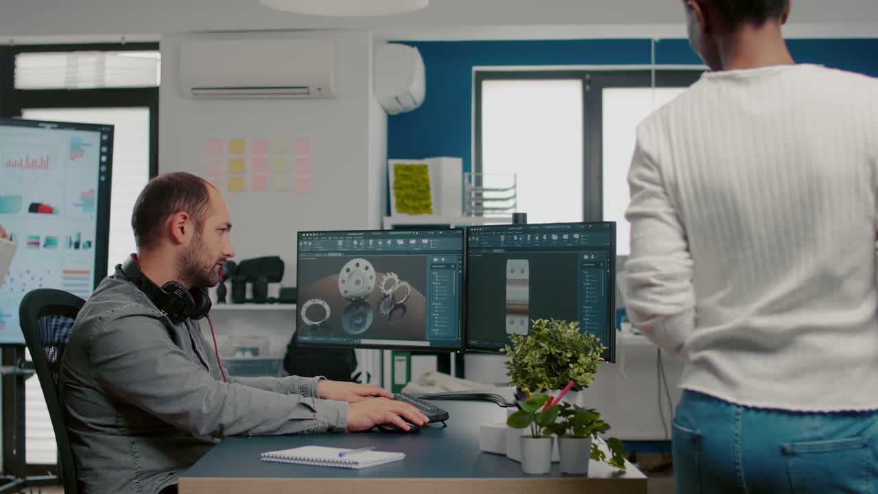 African project manager coming at technician designer discussing