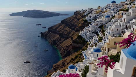 Aerial video captures stunning cliffside white and blue architecture of Santorini, Greece